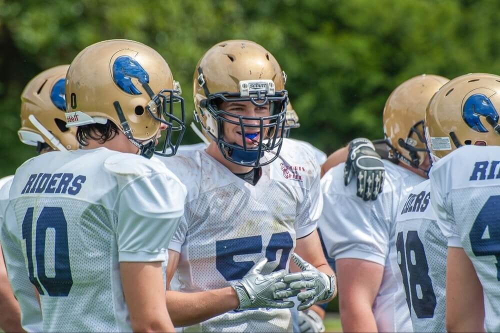 group of football players having a conversation