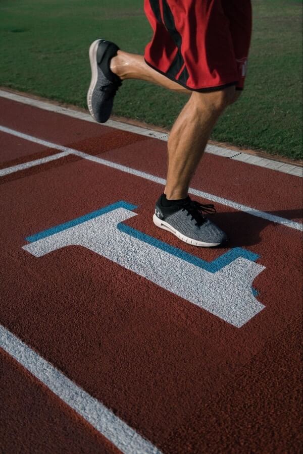 an adult man running in the field