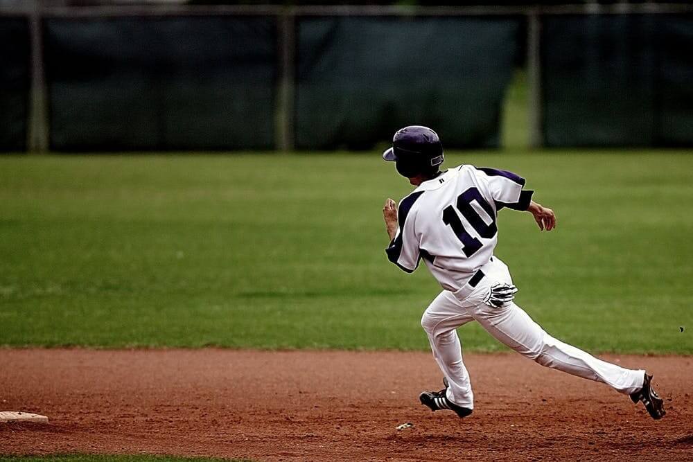 a baseball player running in the field